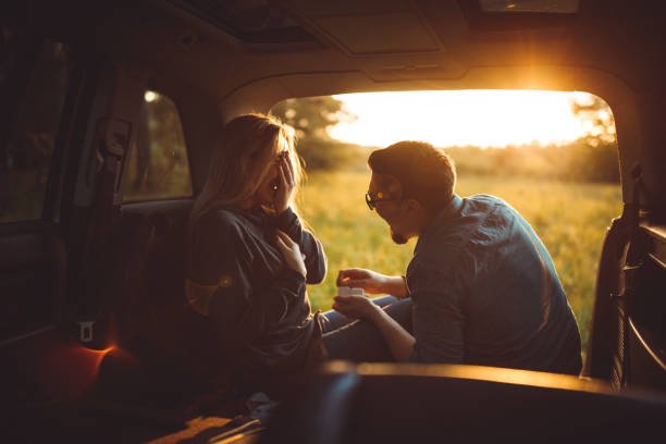 Man proposing his girlfriend in the car